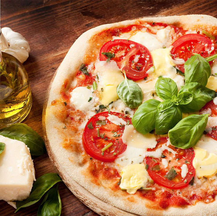 Cheesy Pizza topped with tomato and basil